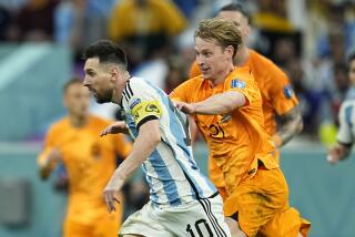 Argentina's Lionel Messi, front, duels for the ball with Frenkie de Jong of the Netherlands.