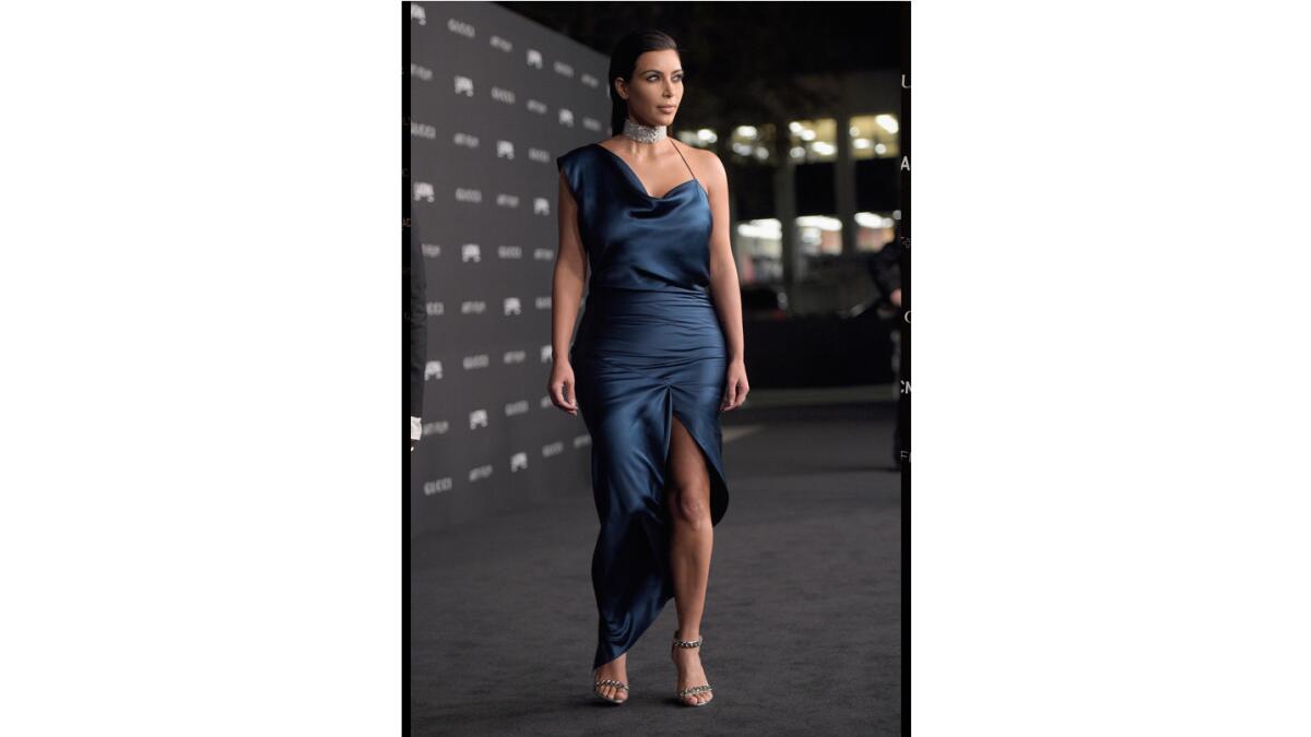 Kim Kardashian wears a tame-for-her teal blue satin, asymmetrical gown designed by Cushnie Et Ochs at LACMA Art + Film.
