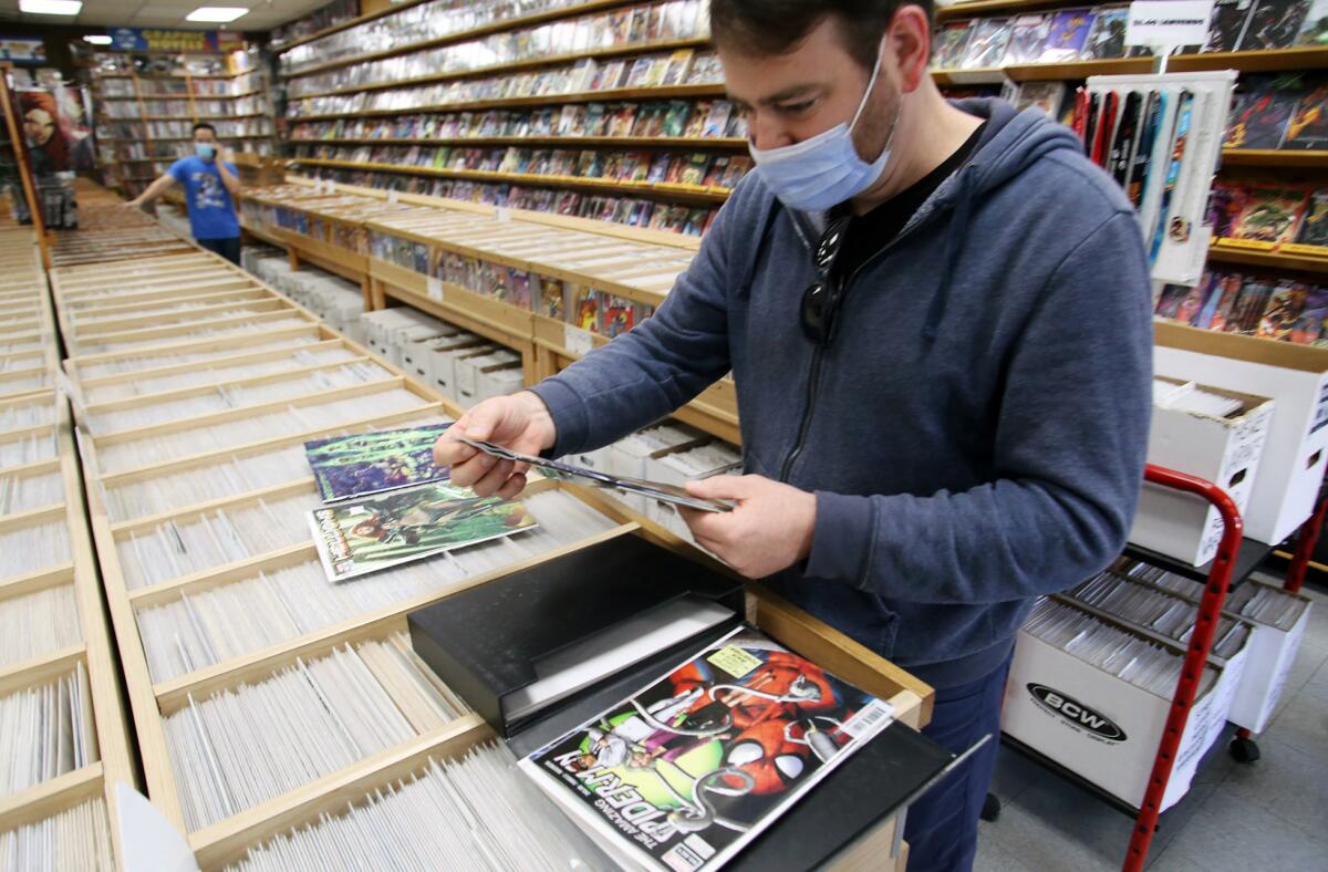 Peter Swanson, of Aliso Viejo, shops for comic books at Comics, Toons & Toys in Tustin. 