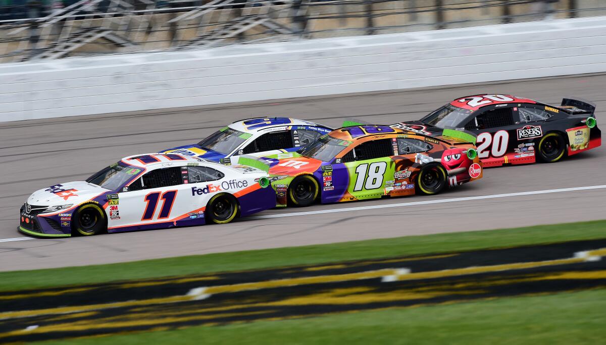 Denny Hamlin (11) leads Chase Elliott (9), Kyle Busch (18) and Erik Jones (20) during the NASCAR race in Kansas City, Kan., on Sunday.