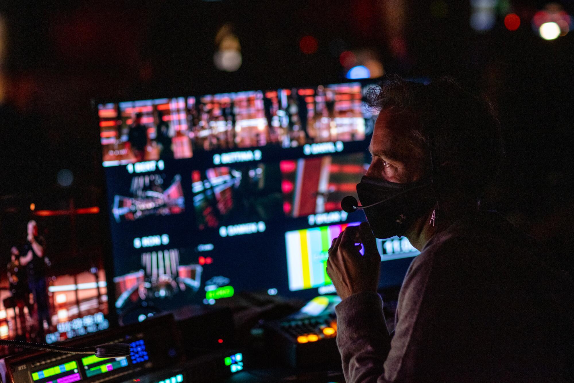 Director Alex Rudzinski at a bank of monitors during rehearsals the day before the 2020 Billboard Music Awards.