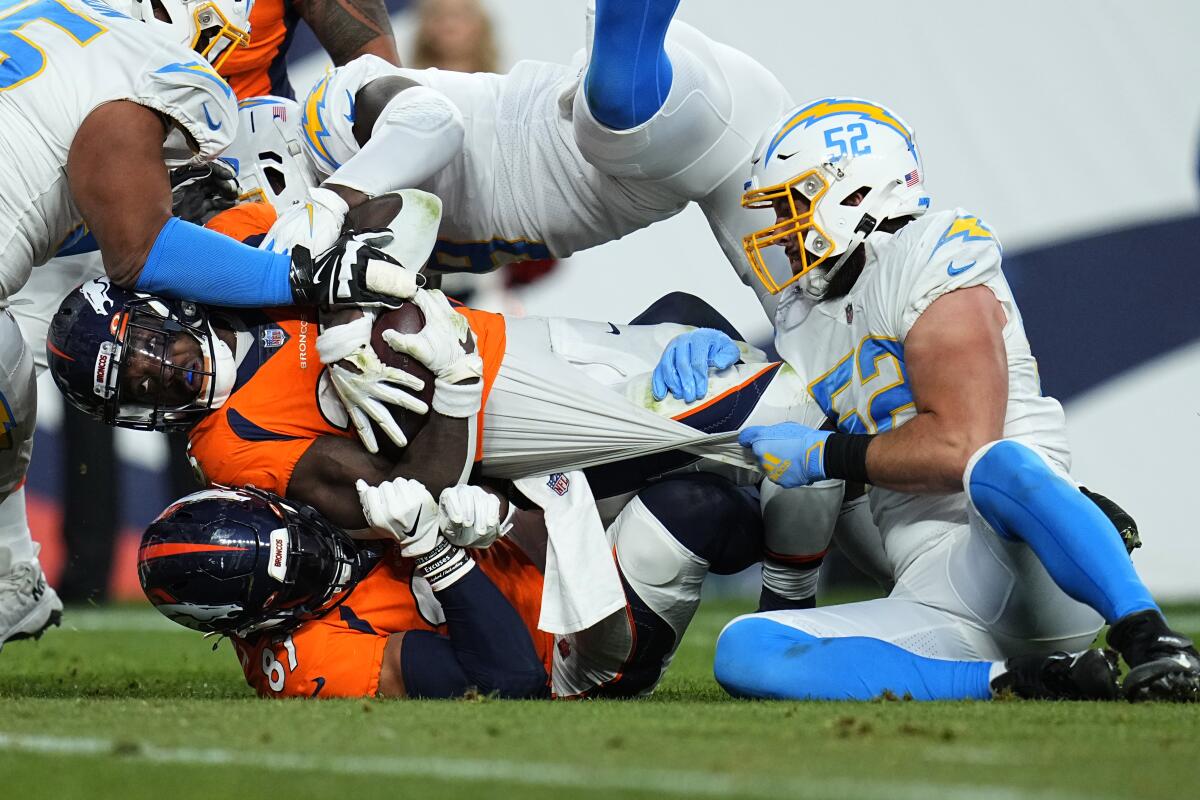 Broncos running back Melvin Gordon is tackled first by Chargers inside linebacker Kyler Fackrell (52) in the second half.