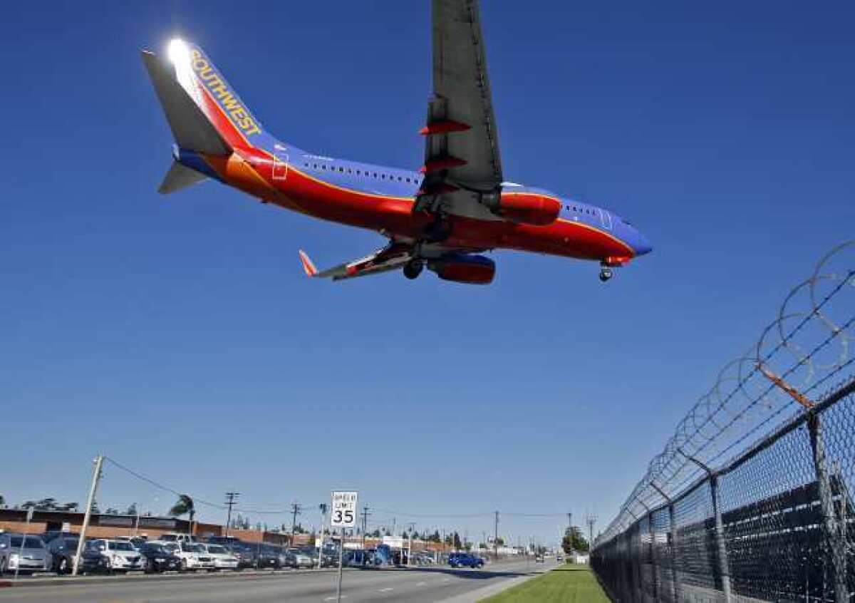 An airplane lands over W. Empire Avenue at the Bob Hope Airport in Burbank. Residents that live near the airport have complained of noise.