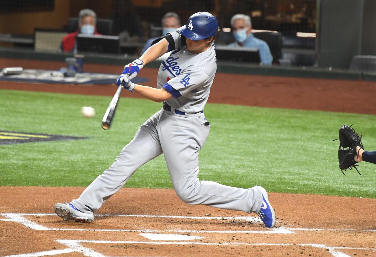 Dodgers shortstop Corey Seager hits a run-scoring single in the first inning.