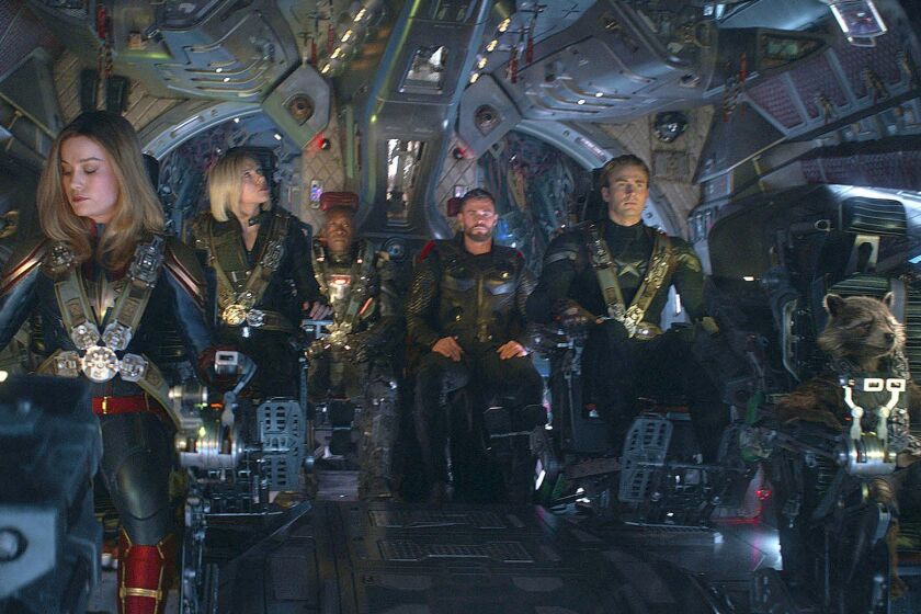 This image released by Disney shows, from left, Brie Larson, Scarlett Johansson, Don Cheadle, Chris Hemsworth, Chris Evans and the character Rocket, voiced by Bradley Cooper, in a scene from Avengers: Endgame. (Disney/Marvel Studios via AP)