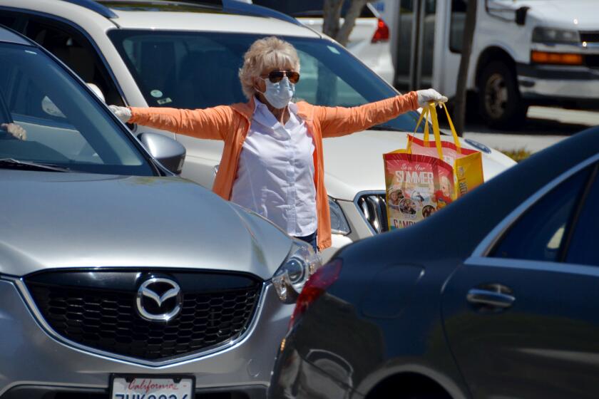 Joy Brenner, Newport Beach City Council member pitched in during the OASIS drive-by mask giveaway on Thursday.