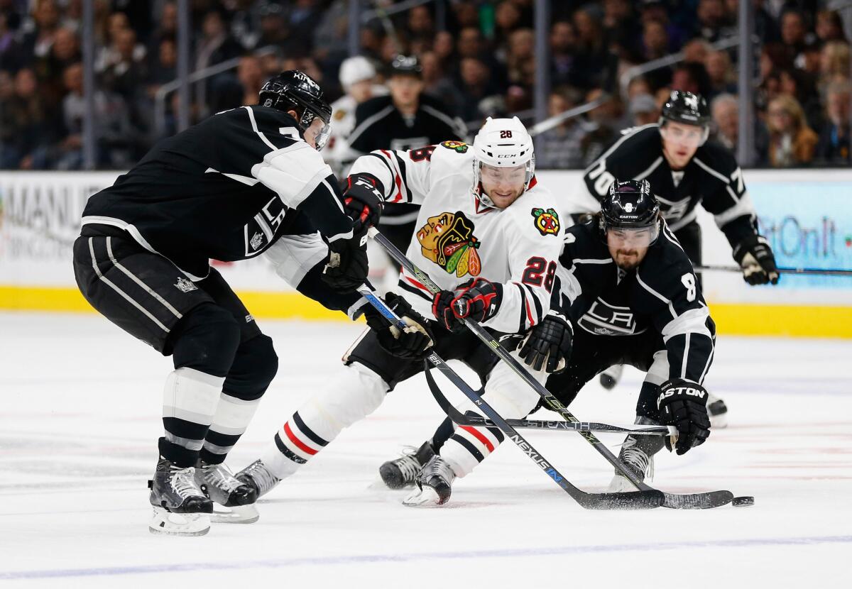 Chicago forward Ryan Garbutt battles with Kings defensemen Drew Doughty (8) and Brayden McNabb (3) during a game on Nov. 28. Garbutt was traded to the Ducks on Jan. 21.