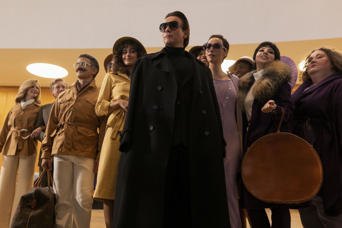 A scene from "Halston" showing Ewan McGregor as the famed fashion designer surrounded by his entourage.