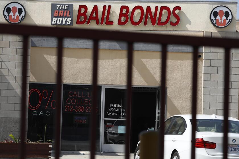 LOS ANGELES, CA - SEPTEMBER 25, 2023 - The Bail Boys Bail Bonds as seen through a rod iron fence in Los Angeles on September 25, 2023. A new pretrial protocol will eliminate money bail for most people in Los Angeles County between their arrest and their arraignment, beginning Oct. 1. (Genaro Molina / Los Angeles Times)