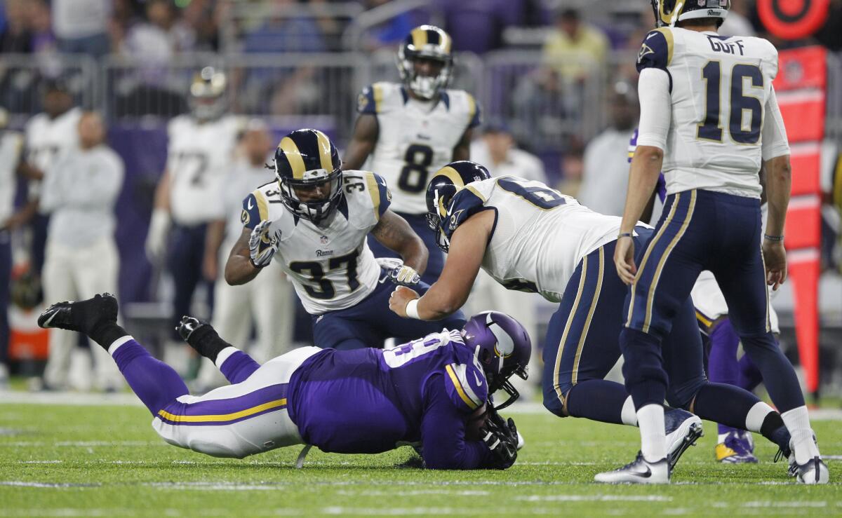 Vikings defensive tackle Toby Johnson dives to intercept a tipped pass of Rams quarterback Jared Goff (16) during the first half.