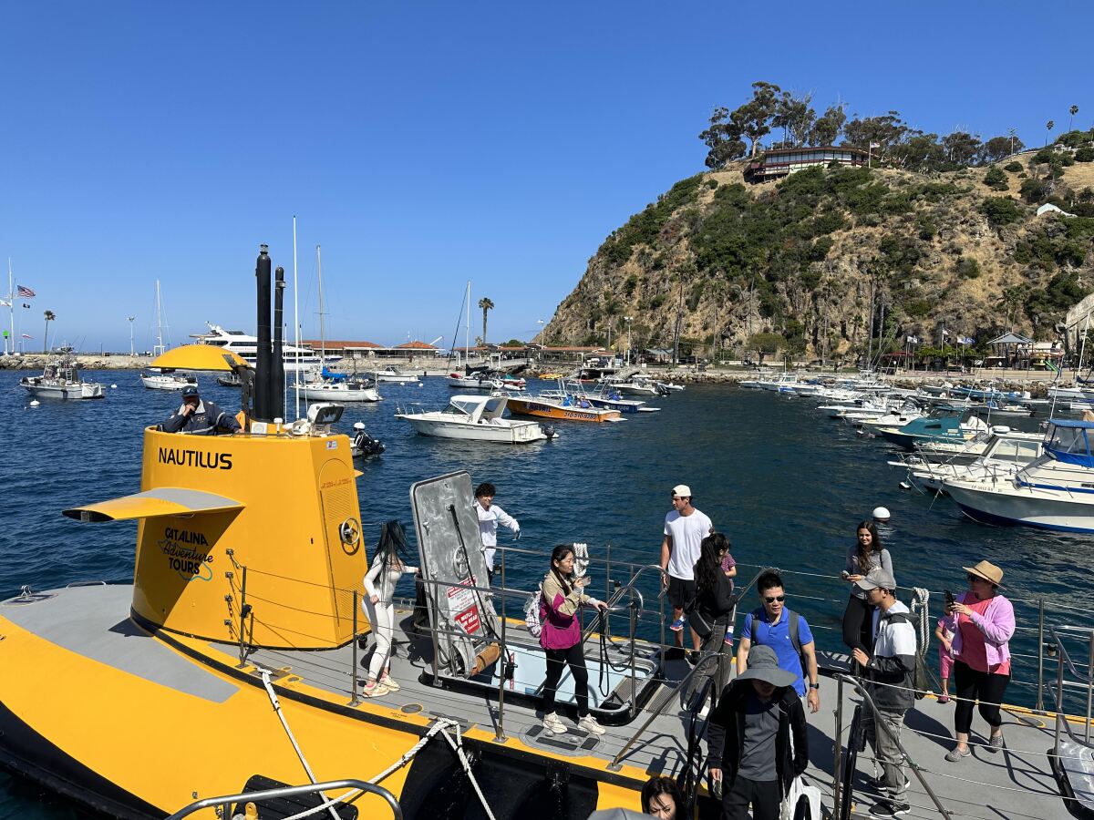 Passengers disembark from the SS Nautilus semi-submersible in Catalina Island's Avalon Bay on Friday.