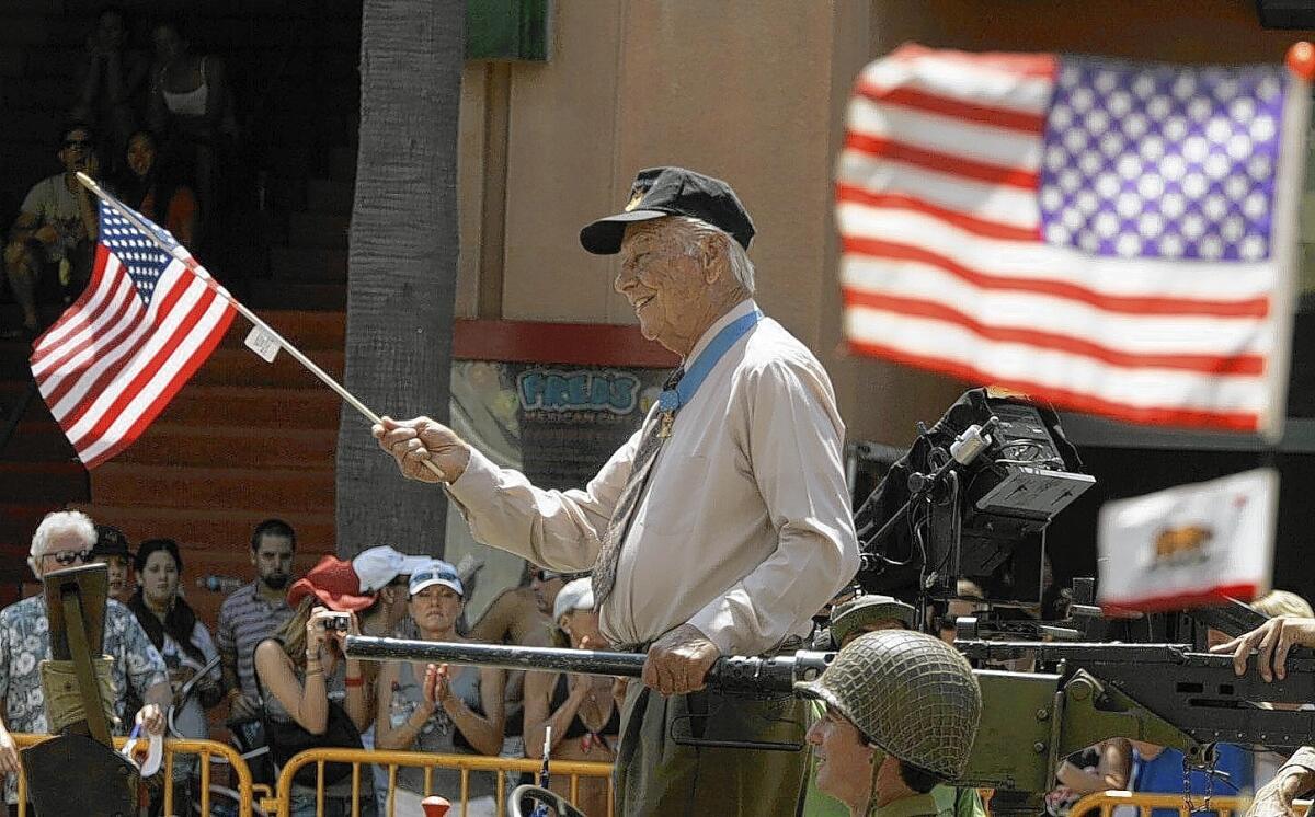 Medal of Honor recipient Walter Ehlers of Buena Park carries a flag in Huntington Beach's 2006 Fourth of July Parade.