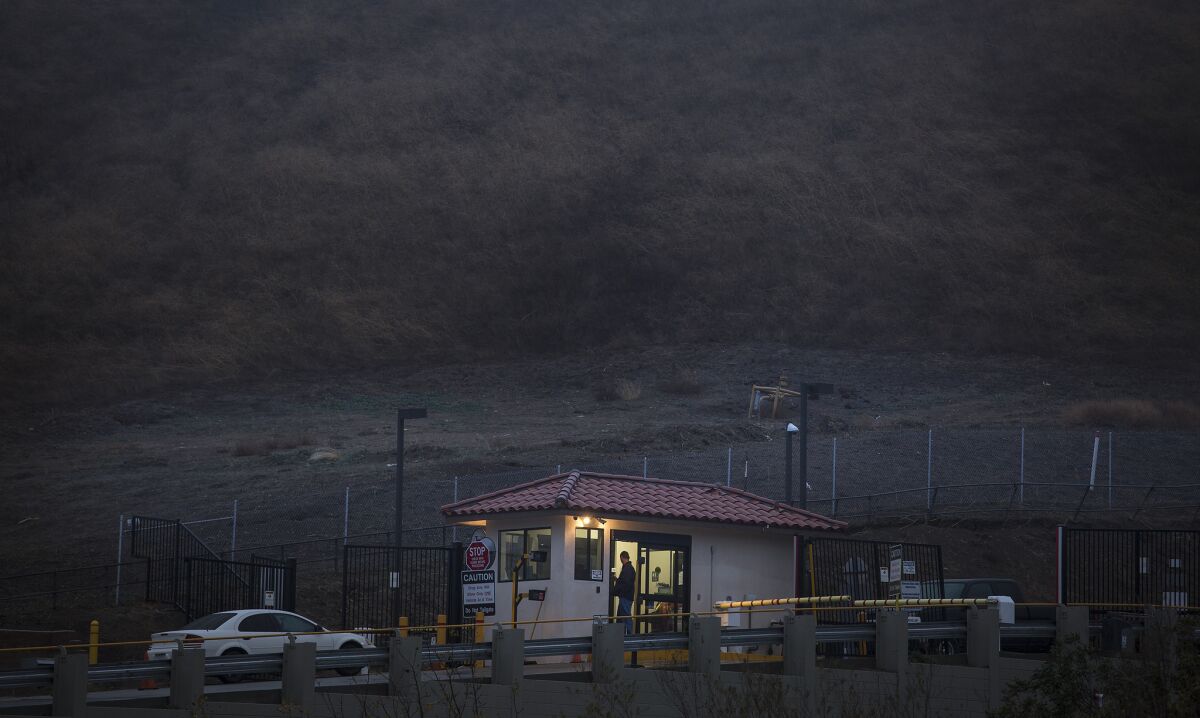 A security guard stands at the entry point to Southern California Gas Co.'s Aliso Canyon storage facility near Porter Ranch.