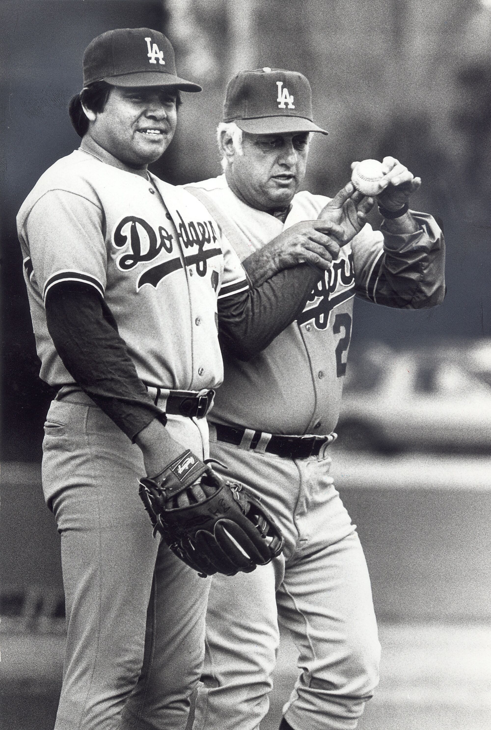 Tommy Lasorda jokingly shows pitcher Fernando Valenzuela how to hold a baseball in March 1983.
