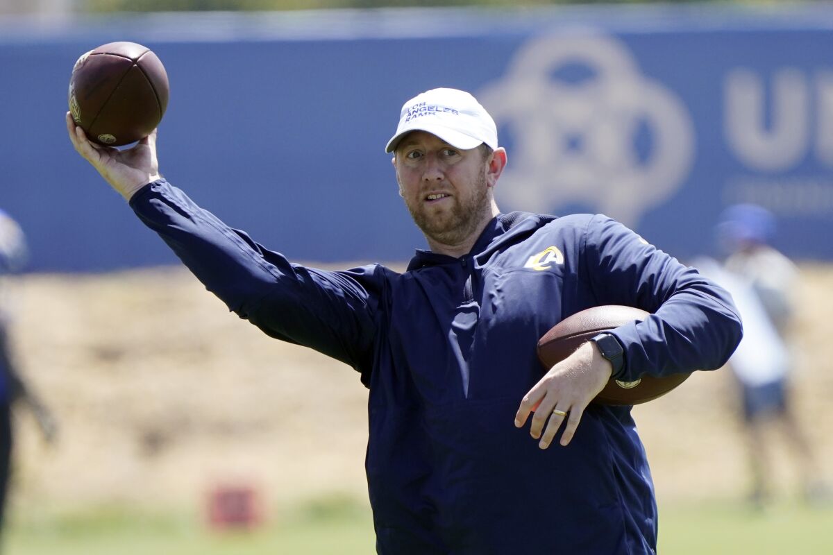 Rams offensive coordinator Liam Coen throws a ball at the team's practice facility in May.