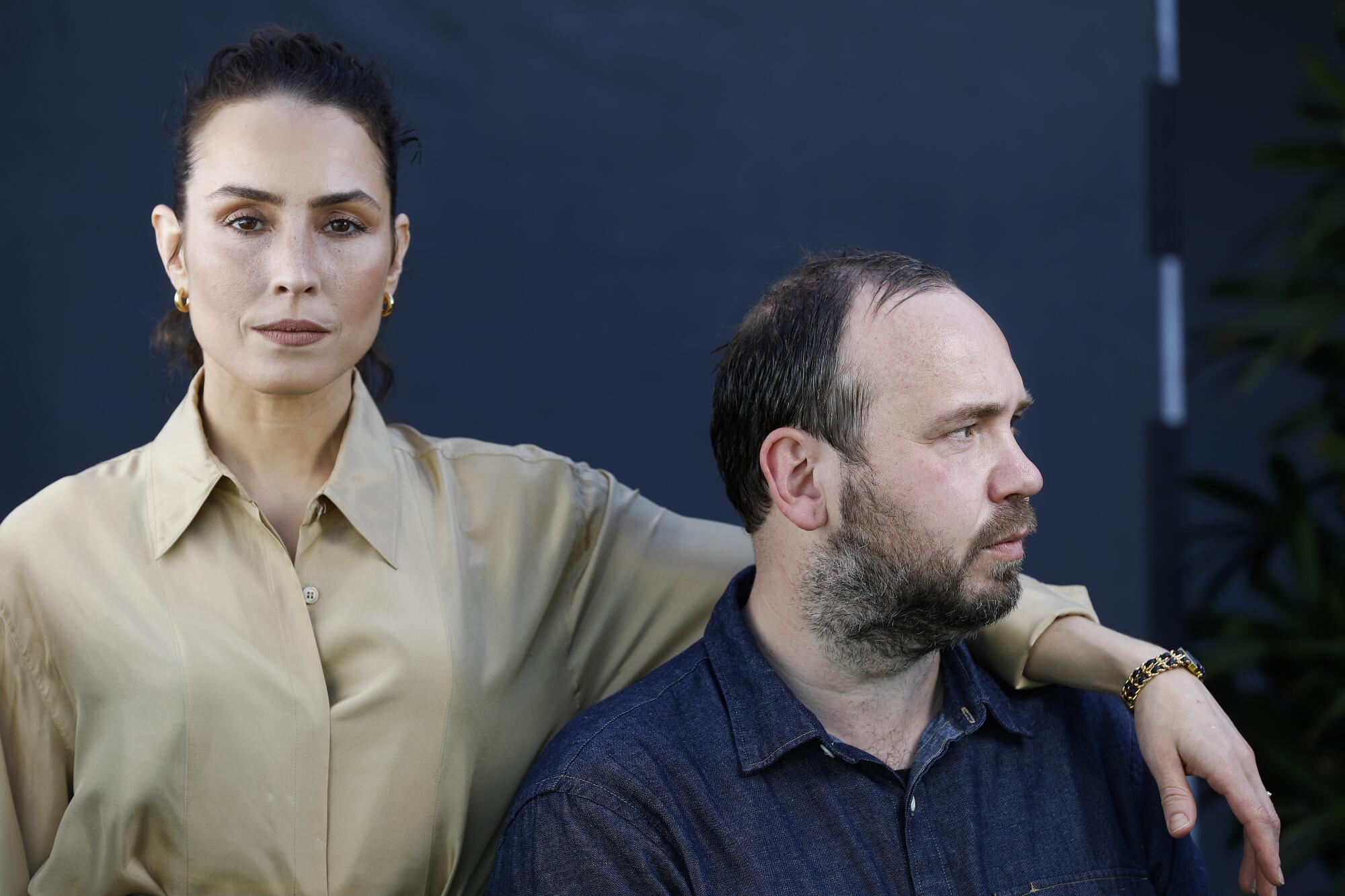 Noomi Rapace drapes her arm over the shoulder of director Valdimar Johannsson