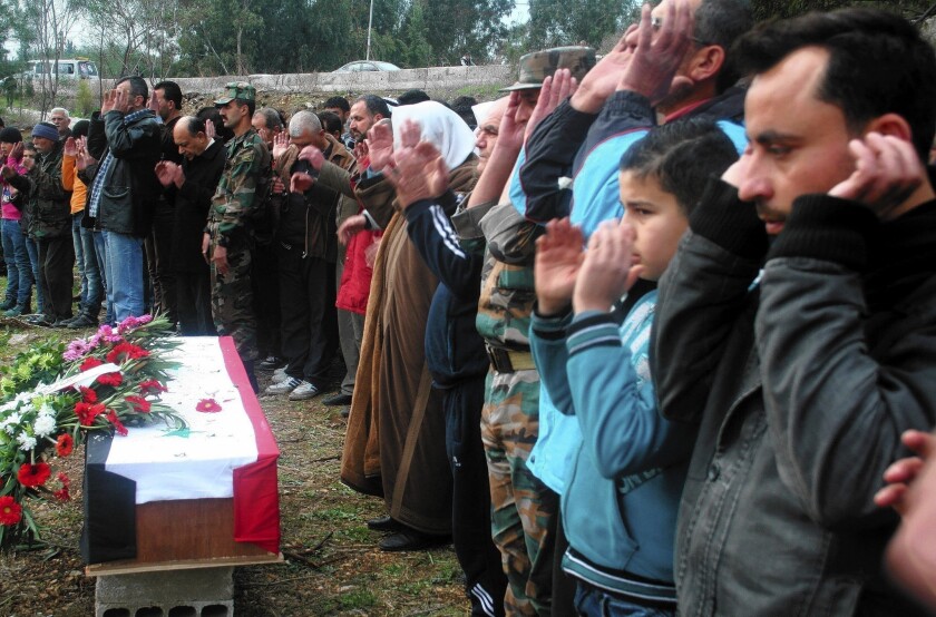 Mourners in Tartus pray over the coffin of a Syrian soldier slain in fighting in the country's civil war. The government of President Bashar Assad has proposed a limited cease-fire, prisoner swap and measures to speed aid to civilians in a move that appeared aimed at ensuring it is an indispensable part of any effort to end the conflict.