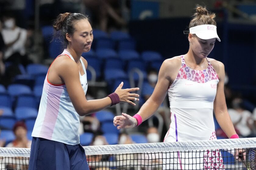 Zheng Qinwen of China, left, and Veronika Kudermetova of Russia, right, greet each other after their singles semifinal match in the Pan Pacific Open tennis championships at Ariake Colosseum Saturday, Sept. 24, 2022, in Tokyo. Zheng defeated Kudermetova. (AP Photo/Eugene Hoshiko)