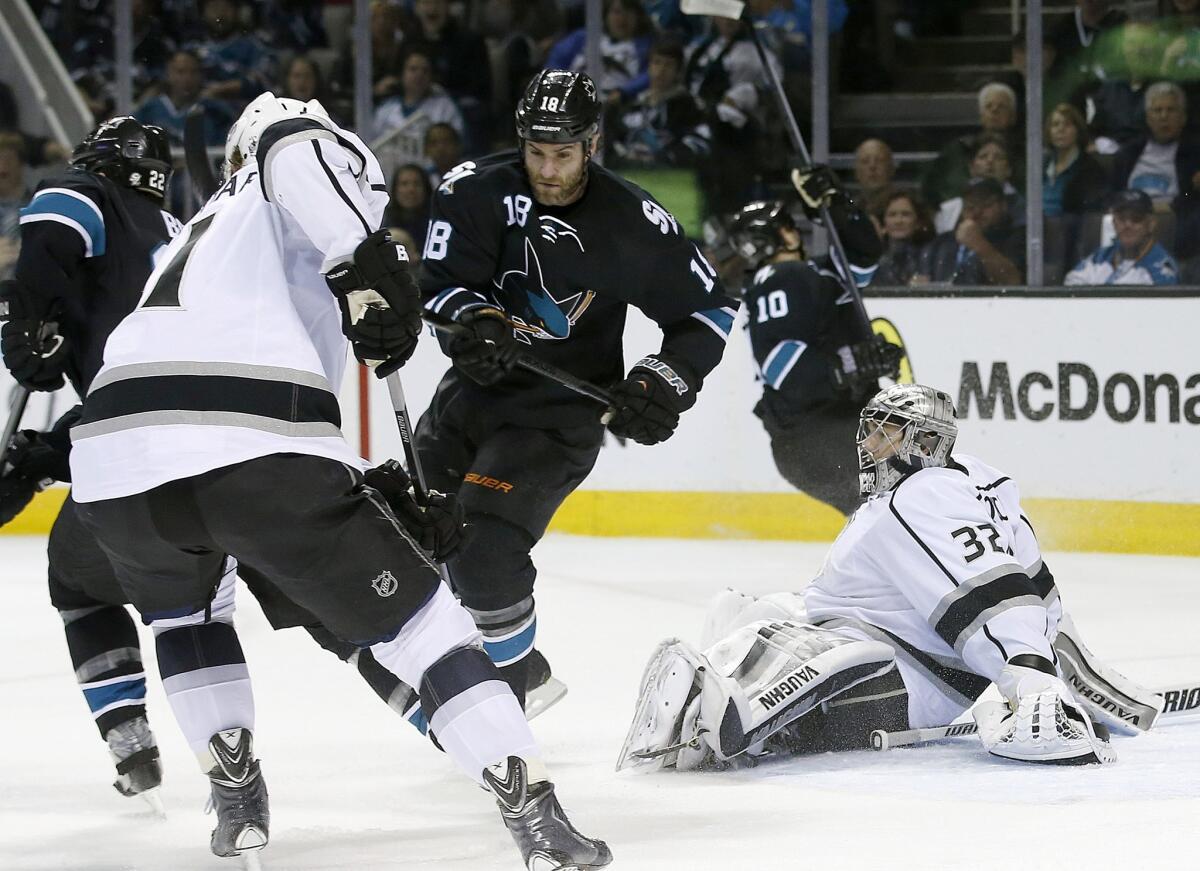 Kings goalie Jonathan Quick stifles a scoring opportunity by San Jose Sharks forward Mike Brown during the first period of Game 5 of the Western Conference quarterfinals at SAP Center in San Jose on April 26, 2014.