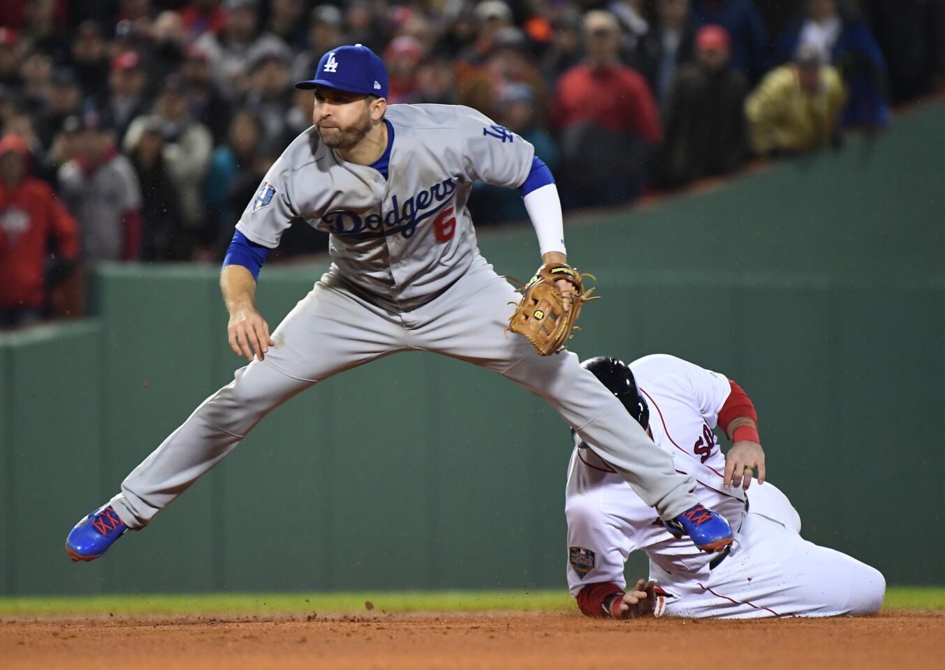 Dodgers second baseman Brian Dozier throws to first as Red Sox Steve Pearce slides in the fifth inning.