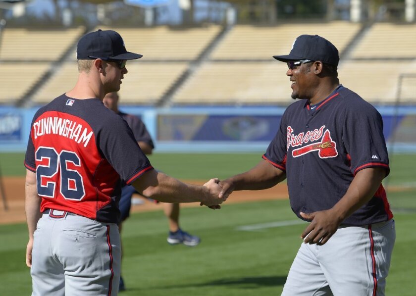 The Braves' Todd Cunningham greets freshly acquired Juan Uribe prior to a May 27 game against the Dodgers at Dodger Stadium.