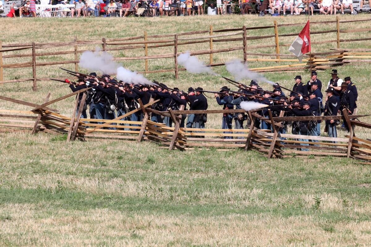 Union reenactors fire their guns during the re-enactment held at the Daniel Lady Farm in Gettysburg, PA on July 6. 