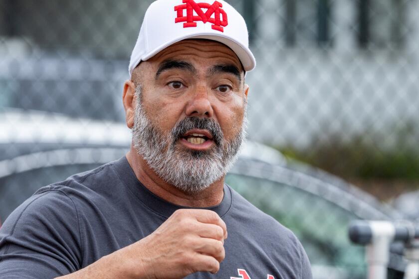 Long Beach, CA - May 18: Mater Dei varsity football head coach Raul Lara coaches the team after a game with Upland in the Long Beach Tournament of Champions at Long Beach Millikan High School Saturday, May 18, 2024. (Allen J. Schaben / Los Angeles Times)