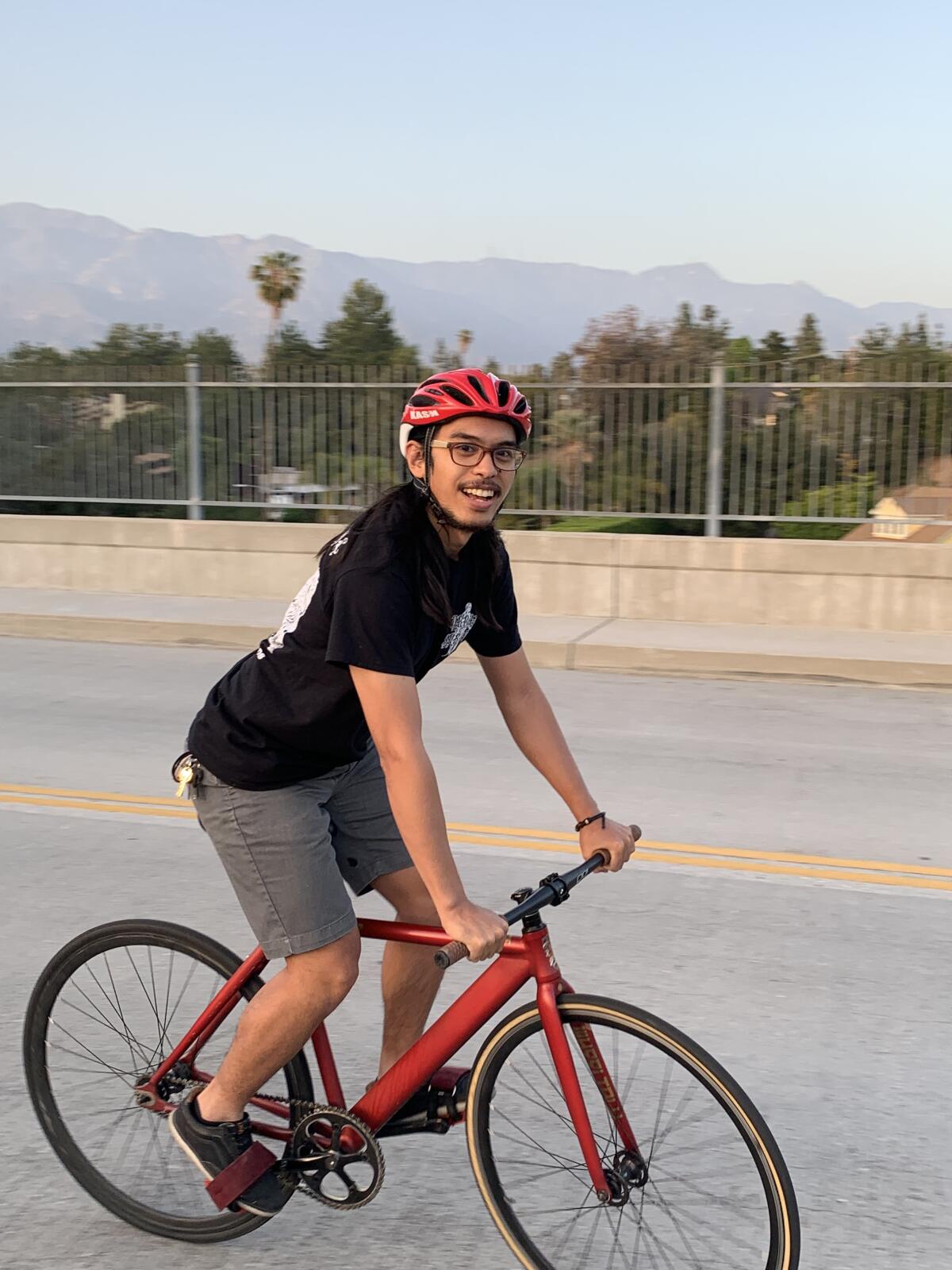 Raymund Florida riding along a bridge above the Arroyo Seco.