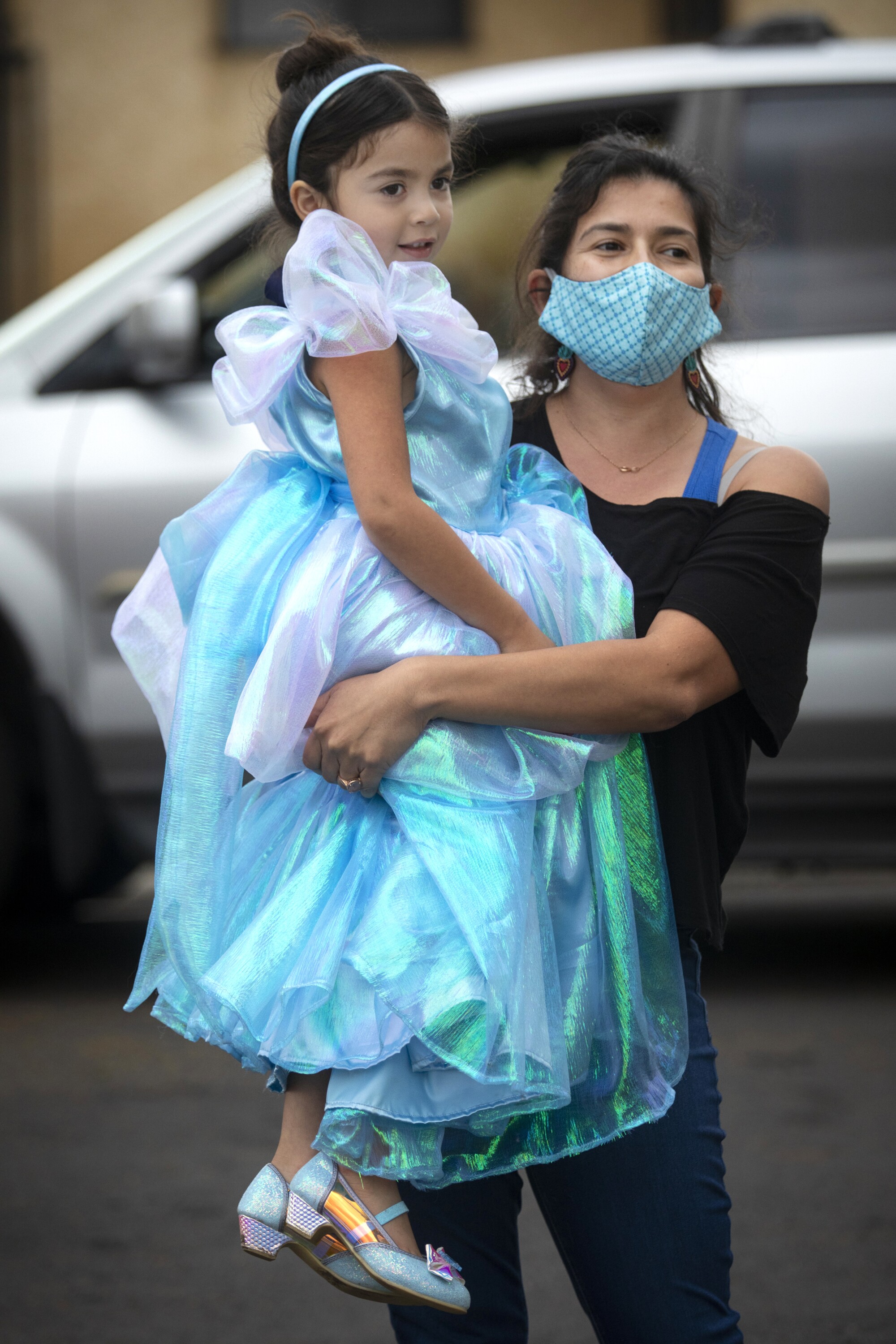 Analis Ilumuna Mosqueda-Mojarro, 5, held by her mom Victoria Mojarro, wore a princess costume to celebrate her own and her great-grandmother Socorro Mojarro Duran's birthdays on Monday in Alhambra.