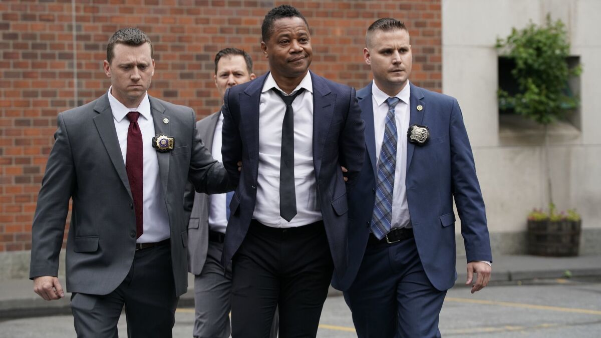 Cuba Gooding, Jr. leaves the Manhattan Special Victims Unit on Thursday after being charged with forcible touching.