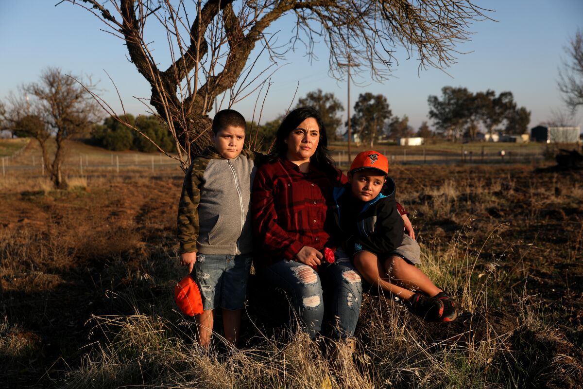 Sonia Bravo, 34, with her twin sons Edward, left, and Joseph, 7.