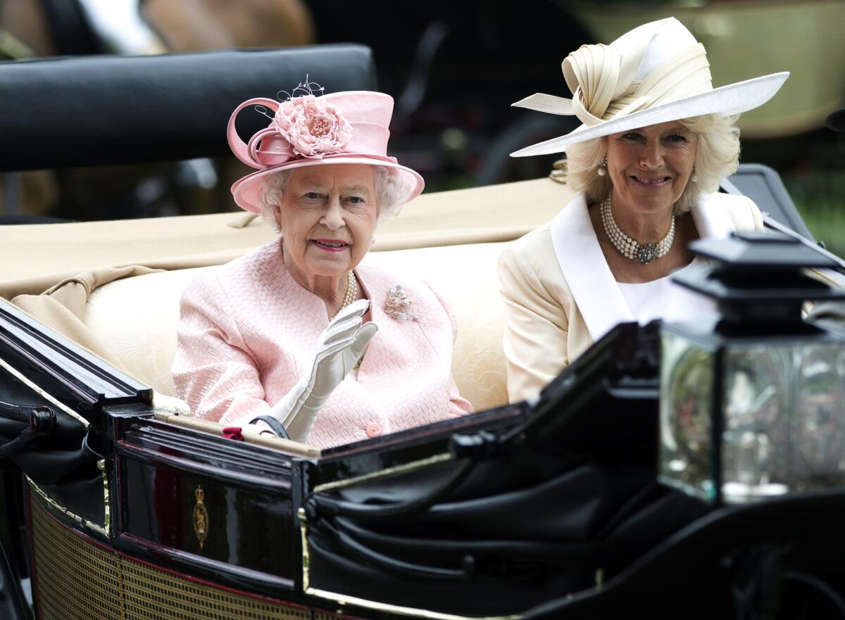 Queen Elizabeth II and Camilla, Duchess of Cornwall, in an open carriage.