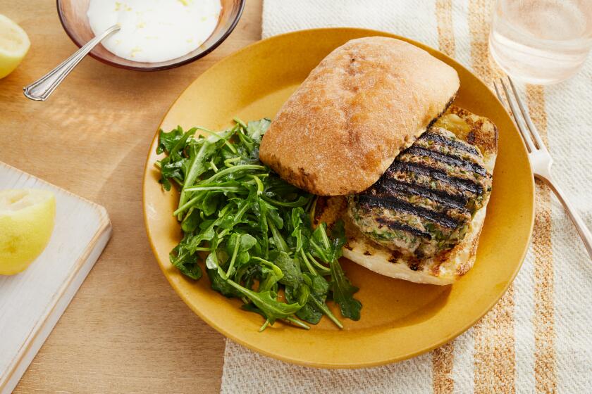 LOS ANGELES CA, SEPT. 24, 2021: Lamb Zucchini Burgers with Yogurt Sauce and Arugula Salad photographed for the Los Angeles Times food column on Friday Sept. 24, 2021 at Proplink Studios in Arts District Los Angeles. Prop Styling by Kate Parisan.