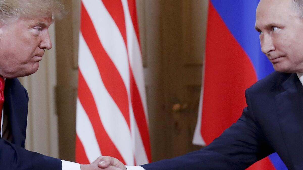 President Trump and Russian leader Vladimir Putin shake hands at the beginning of their meeting in Helsinki, Finland, on July 16.