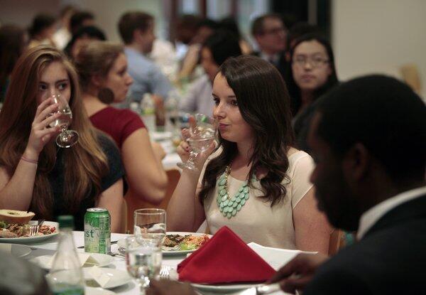 MIT freshman Julia Heyman, 19, of Encinitas, center, and other MIT students learn about table manners during a recent workshop at the university.