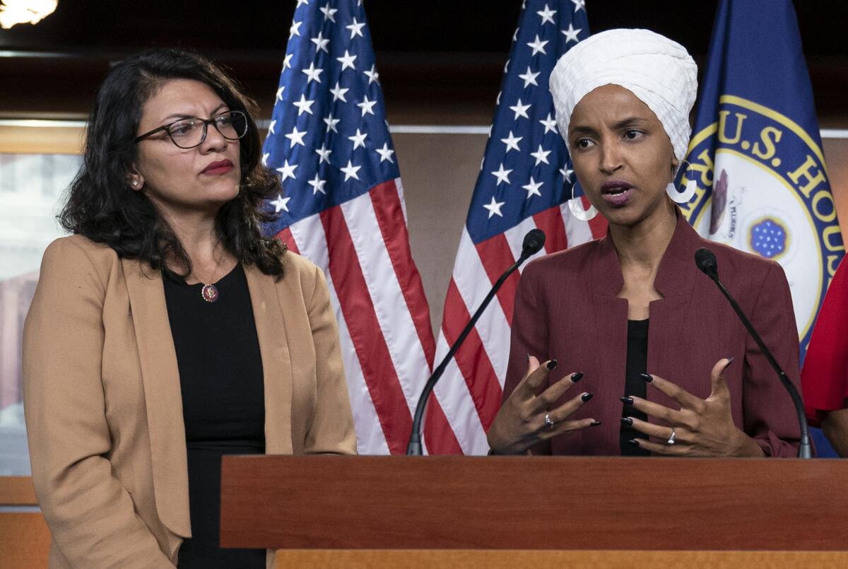 FILE - In this July 15, 2019, file photo, U.S. Rep. Ilhan Omar, D-Minn, right, speaks, as U.S. Rep. Rashida Tlaib, D-Mich. listens, during a news conference at the Capitol in Washington. In the eyes of critics, Benjamin Netanyahu’s decision to bar two Democratic congresswomen at the request of President Donald Trump is the latest reckless gamble by a prime minister willing to sacrifice Israel’s national interests for short-term gain. And yet the pursuit of such allegedly short-term gains has kept Netanyahu in power for more than a decade. (AP Photo/J. Scott Applewhite, File)