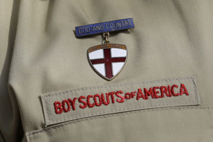 FILE - In this Feb. 4, 2013 file photo, shows a close up detail of a Boy Scout uniform worn during a news conference in front of the Boy Scouts of America headquarters in Irving, Texas. The Boy Scouts of America says it is exploring "all options" to address serious financial challenges, but is declining to confirm or deny a report that it may seek bankruptcy protection in the face of declining membership and sex-abuse litigation. "I want to assure you that our daily mission will continue and that there are no imminent actions or immediate decisions expected," Chief Scout Executive Mike Surbaugh said in a statement issued Wednesday, Dec. 12, 2018. (AP Photo/Tony Gutierrez, File)