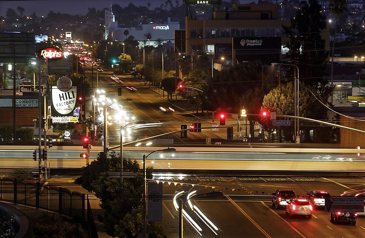 A Metro Expo Line train crosses Crenshaw Boulevard at Exposition Boulevard in the Crenshaw District of Los Angeles. A new light-rail line will run from the intersection of Crenshaw and Exposition toward LAX.