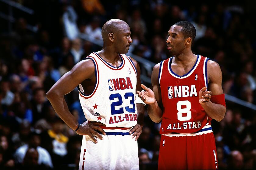 ATLANTA - FEBRUARY 9: Kobe Bryant #8 of the Western Conference All Stars talks with Michael Jordan #23 of the Eastern conference All Stars during the 2003 NBA All-Star Game at the Phillips Arena on February 9, 2003 in Atlanta, Georgia. The West won 155-145 in the first ever double-overtime All-Star Game. NOTE TO USER: User expressly acknowledges and agrees that, by downloading and/or using this Photograph, User is consenting to the terms and conditions of the Getty Images License Agreement. Mandatory Copyright Notice: Copyright 2003 NBAE (Photo by Andrew D. Bernstein/NBAE via Getty Images)