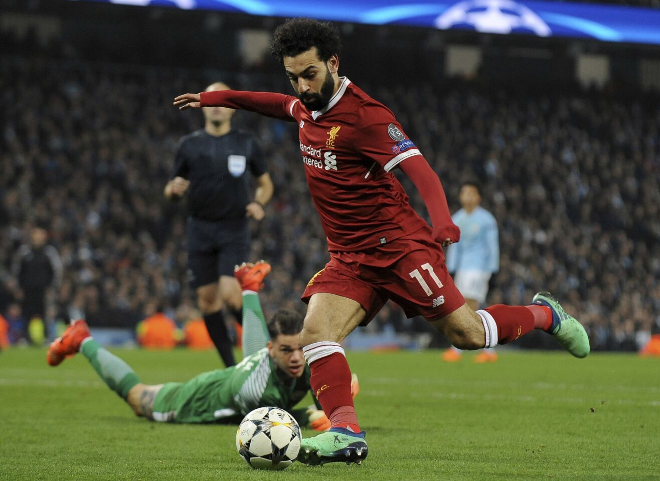 Liverpool's Mohamed Salah scores his side's first goal during the Champions League quarterfinal second leg soccer match between Manchester City and Liverpool at Etihad stadium in Manchester, England, Tuesday, April 10, 2018.