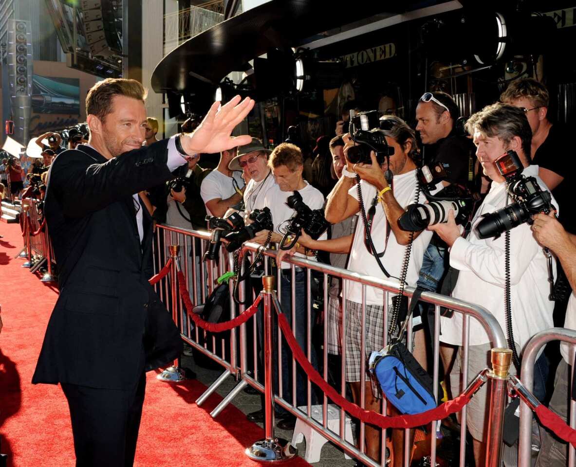 Hugh Jackman greets fans when he arrives on the red carpet