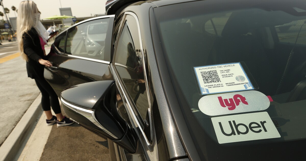 A woman getting into a car at the Rideshare Lot at LAX.