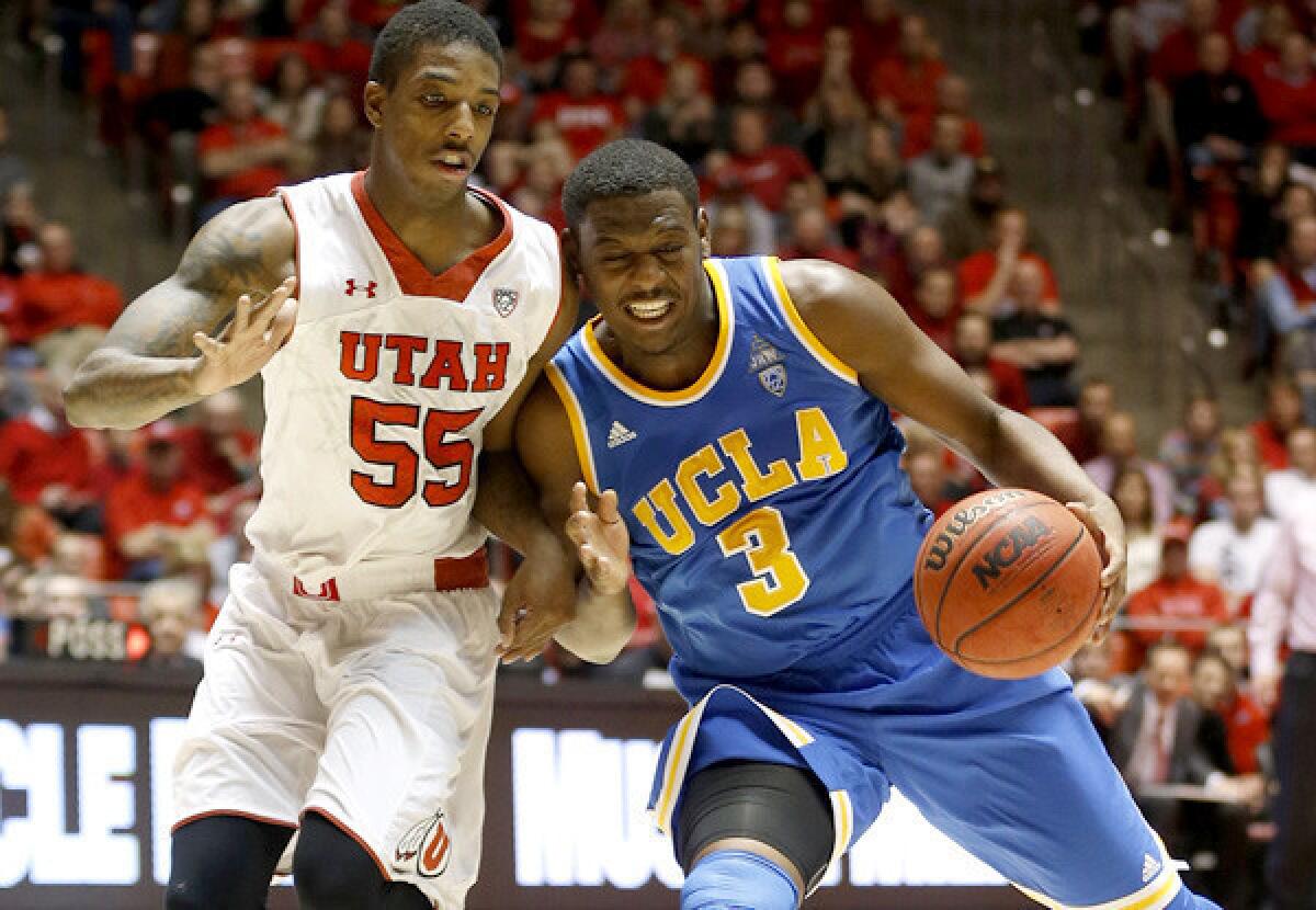 UCLA guard Jordan Adams (3) has his drive cut off by Utah guard Delon Wright in the second half Saturday.