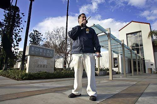 A federal customs investigator, who wouldn't give his name, stands guard outside the Bowers Museum in Santa Ana.