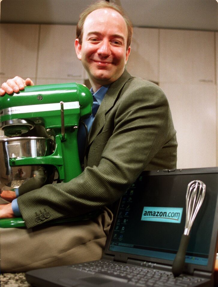 Amazon CEO Jeff Bezos holds a mixer in the Chicago Tribune test kitchen in 2000, when Amazon was beginning to sell houseware goods.