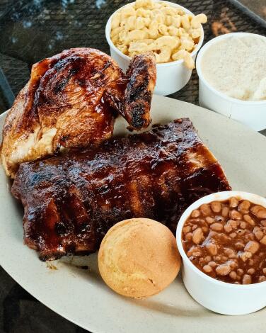 A rack of pork ribs and a quarter chicken with mac and cheese, beans and mashed potatoes at Rib Ranch BBQ 