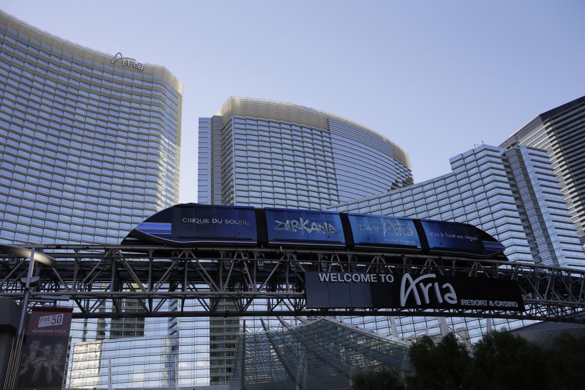 A tram travels by the Aria Resort & Casino in Las Vegas. At several Las Vegas resorts, including the Aria, guests will be hit with a $25 fee for putting their own items in the mini bar.
