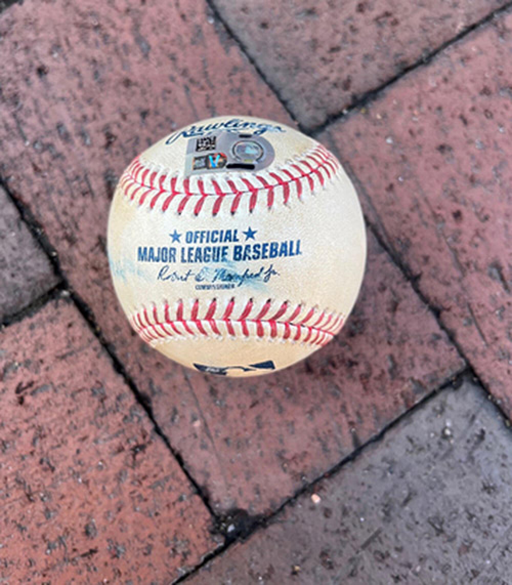 The current bid for Mike Trout's opening day home run ball is $7,010.00. The MLB hologram sticker authenticated the ball. 