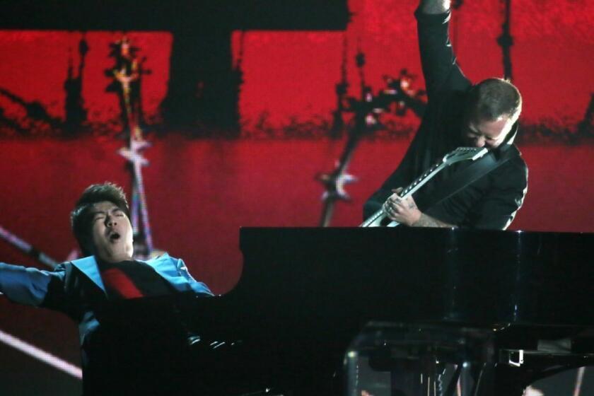 Pianist Lang Lang performs with James Hetfield of Metallica at the Grammy Awards at Staples Center in Los Angeles.