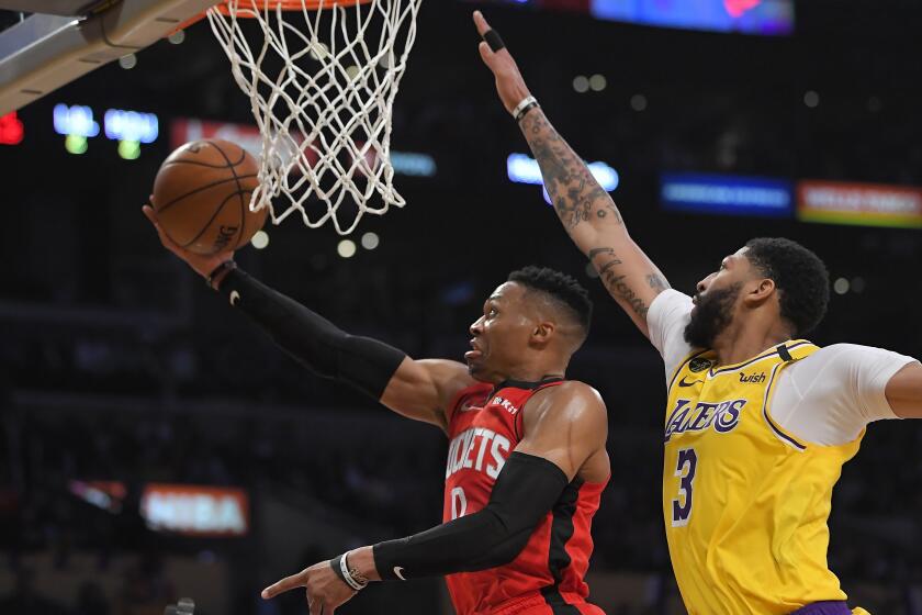 Houston Rockets guard Russell Westbrook, left, shoots as Los Angeles Lakers forward Anthony Davis defends during the second half of an NBA basketball game Thursday, Feb. 6, 2020, in Los Angeles. The Rockets won 121-111. (AP Photo/Mark J. Terrill)